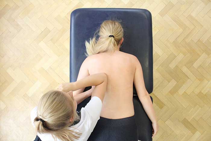 Customer receiving upper back massage while in a relaxed position