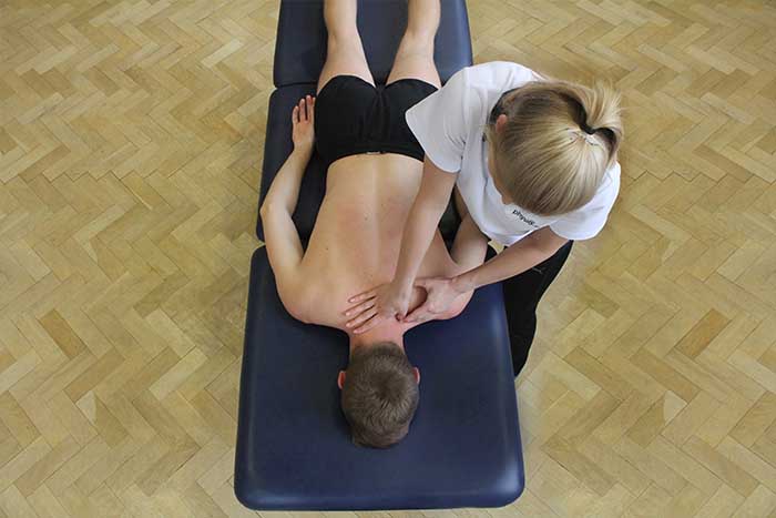 Customer receiving shoulder massage in relaxed position in Manchester Physio Clinic Customer receiving shoulder massage in relaxed position in Manchester Physio Clinic