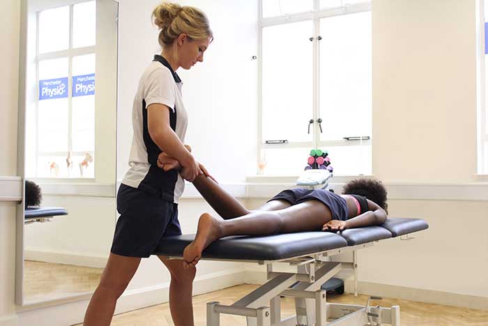 Customer receiving a calf massage while in a relaxed position Customer receiving a calf massage while in a relaxed position