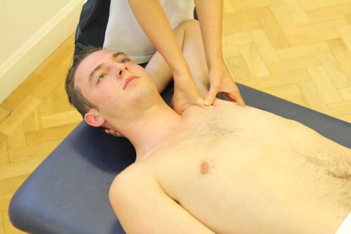 Customer receiving upper shoulder massage in Manchester Physio Clinic Customer receiving upper shoulder massage in Manchester Physio Clinic