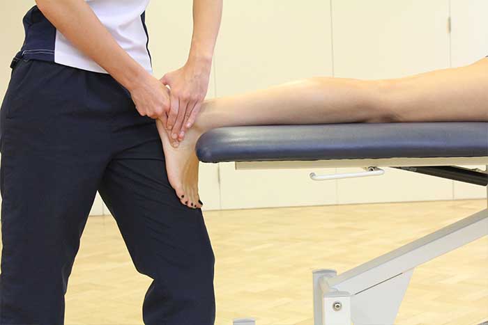 Customer reciving foot massage while in relaxed position in Manchester Physio Clinic