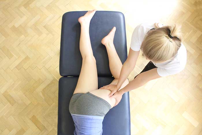 Customer receiving an upper back massage while in a relaxed position in Manchester Physio Clinic Customer receiving upper back massage while in a relaxed position in Manchester Physio Clinic