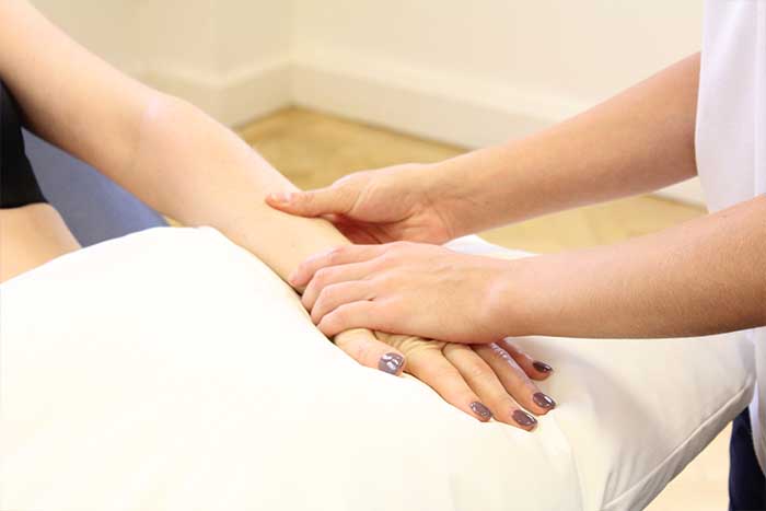 Customer reciving hand massage while in a relaxed position in Manchester Physio Clinic