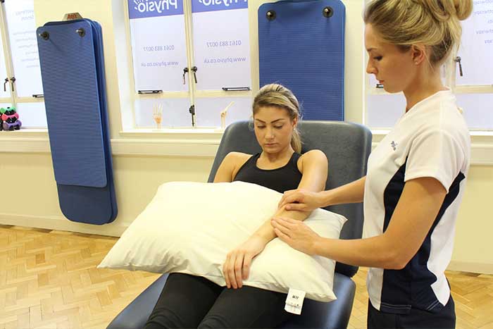 Customer receiving arm massage while in a relaxed position