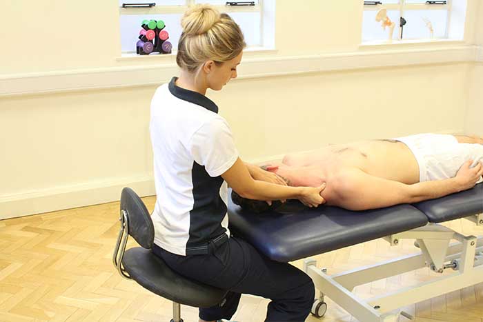 Customer receiving upper shoulder massage, in a relaxed position Customer receiving upper shoulder massage, in a relaxed position