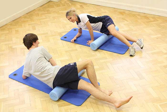 Customer given stretching techniques by massage instructor in Manchester Physio Clinic