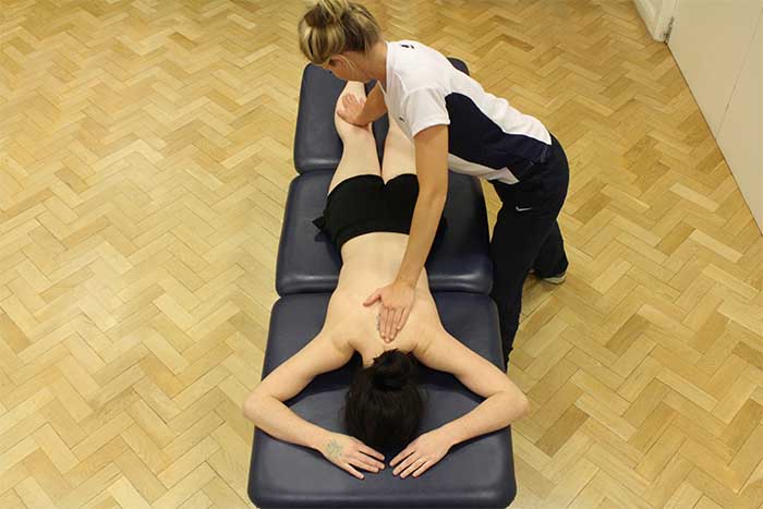 Customer reciving upper back massage in a relaxed position in Manchester Physio Clinic Customer reciving upper back massage in a relaxed position in Manchester Physio Clinic