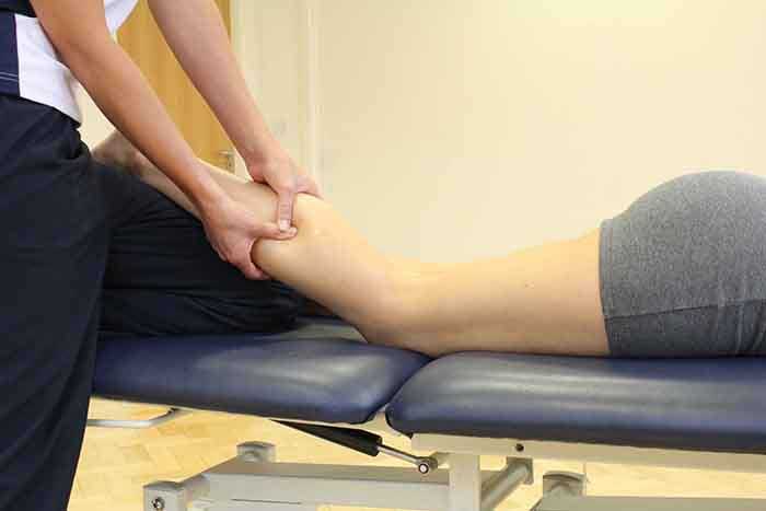 Customer recieveing a calf massage in Manchester Physio Clinic Customer recieveing a calf massage in Manchester Physio Clinic