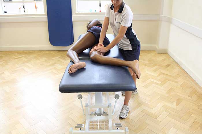 Customer receiving upper leg massage in Manchester Physio Clinic