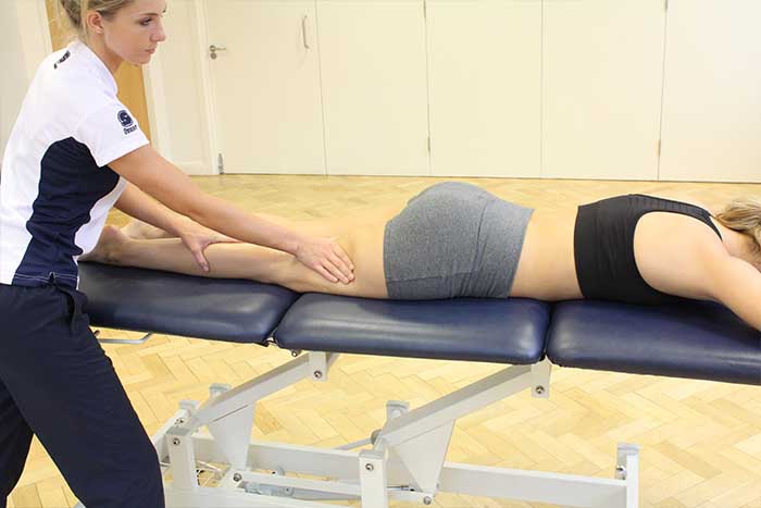 Customer receiving a calf massage while in a relaxed position