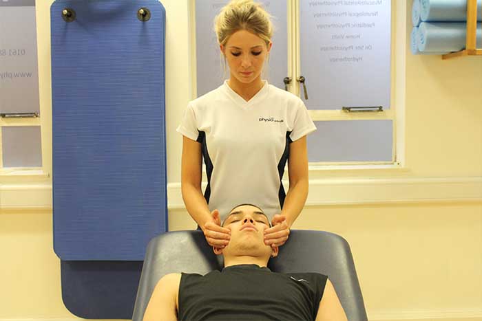 Customer receiving a jaw massage while in a relaxed position