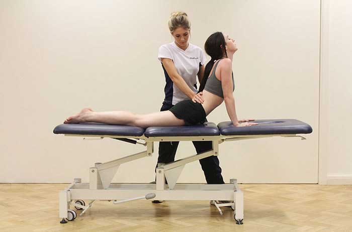 Customer maintaining back stretches in Manchester Physio Clinic