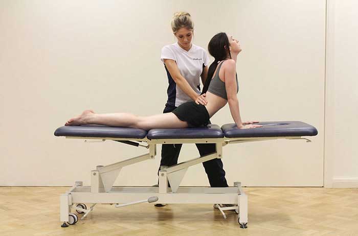 Customer maintaining back stretches in Manchester Physio Clinic Customer maintaining back stretches in Manchester Physio Clinic
