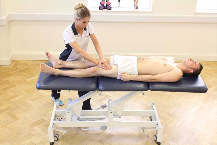 Customer receiving a thigh massage while in a relaxed position in Manchester Physio Clinic Customer receiving a thigh massage while in a relaxed position in Manchester Physio Clinic