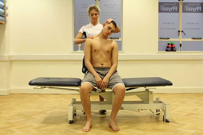 Customer receiving a neck stretch while in a relaxed position in Manchester Physio Clinic Customer receiving a neck stretch while in a sitting up position in Manchester Physio Clinic
