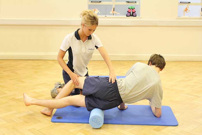 Customer receiving leg muscle stretches