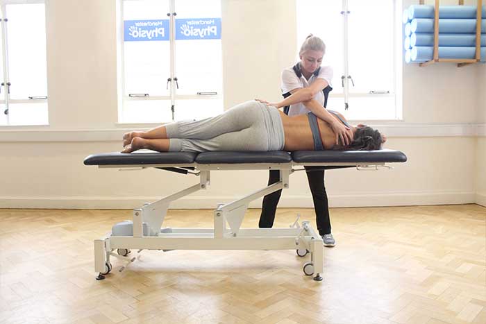 Customer receiving upper back massage while in a relaxed position in Manchester Physio Clinic Customer receiving upper back massage while in a relaxed position in Manchester Physio Clinic