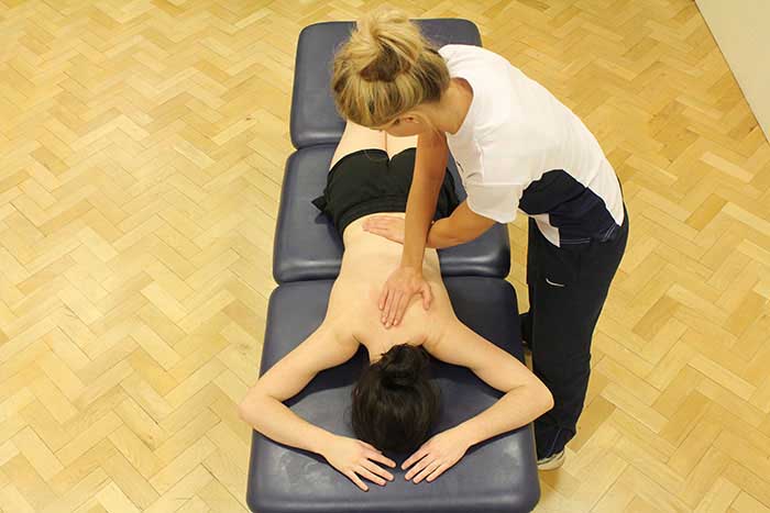Customer receiving back massage while in a relaxed position in Manchester Physio Clinic Customer receiving back massage while in a relaxed position in Manchester Physio Clinic