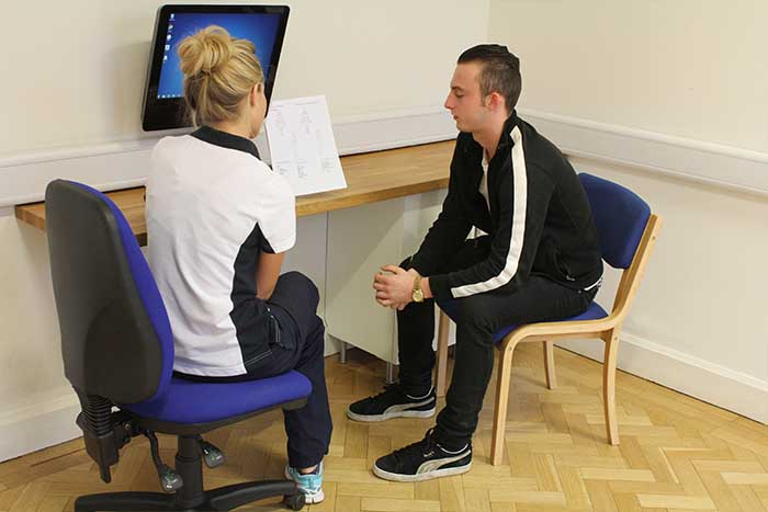 Customer receiving after session guidance from instructor in Manchester Physio Clinic Customer receiving after session guidance from instructor in Manchester Physio Clinic