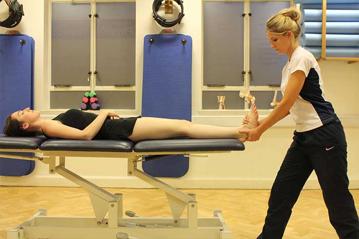 Customer receiving foot massage while in relaxed position in Manchester Physio Clinic