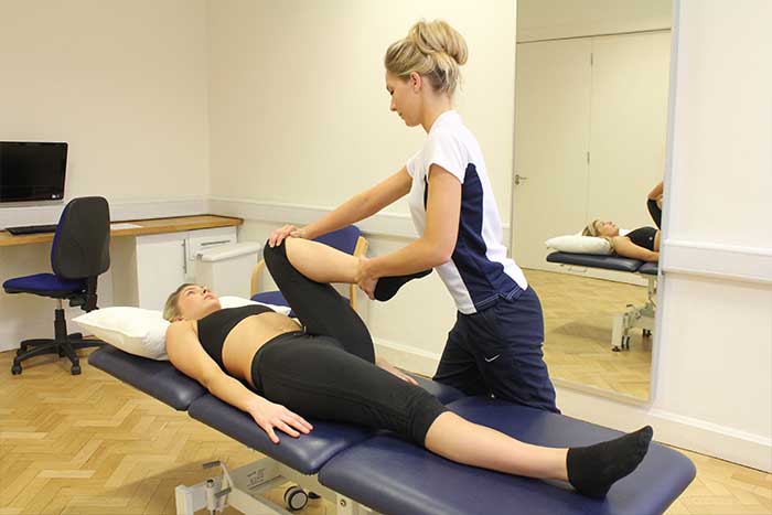 Customer receiving leg stretch while in a relaxed position Customer receiving leg stretch while in a relaxed position