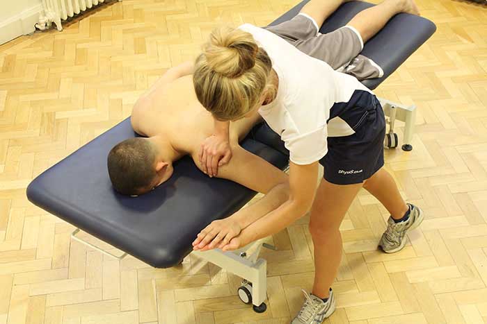 Customer receiving arm massage while in a relaxed position