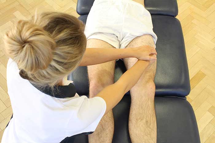Customer receiving thigh massage while in a relaxed position Customer receiving thigh massage while in a relaxed position