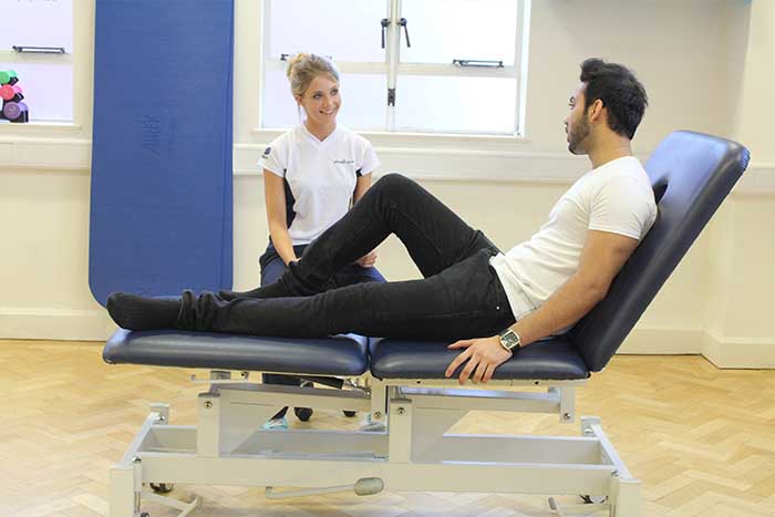 Customer receiving leg stretches while in a relaxed position