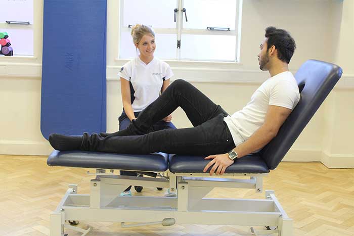 Customer receiving leg stretches while in a relaxed position Customer receiving leg stretches while in a relaxed position