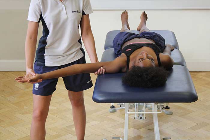 Customer reciving arm stretches and massage in Manchester Physio Clinic