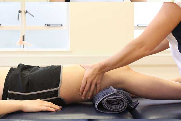 Customer reciving upper leg massage while lay in a relaxed position in Manchester Physio Clinic Customer reciving upper leg massage while lay in a relaxed position in Manchester Physio Clinic