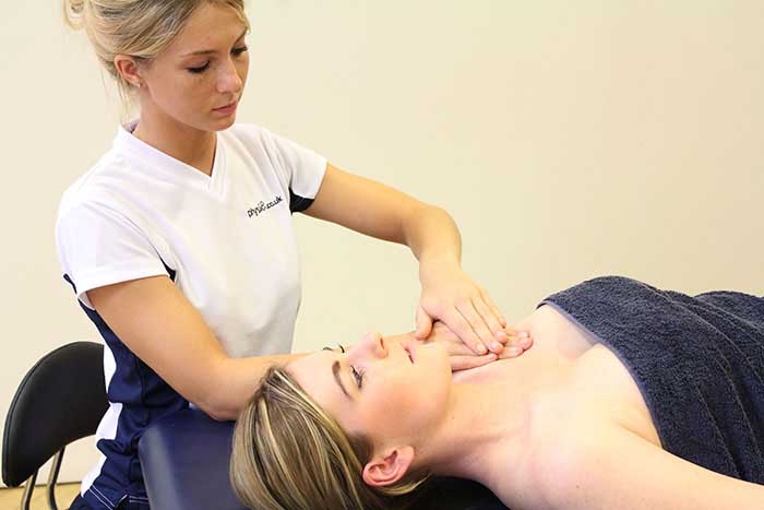 Customer receiving a chest massage while in a relaxed position in Manchester Physio Clinic Customer receiving a chest massage while in a relaxed position in Manchester Physio Clinic