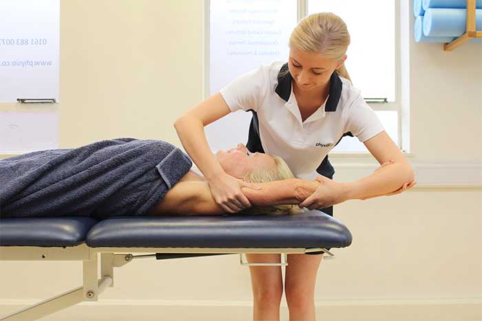 Customer receiving an arm massage while in a relaxed position in Manchester Physio Clinic Customer receiving an arm massage while in a relaxed position in Manchester Physio Clinic