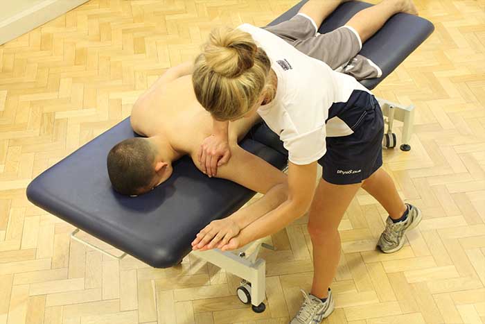 Customer receiving an arm massage while in a relaxed position