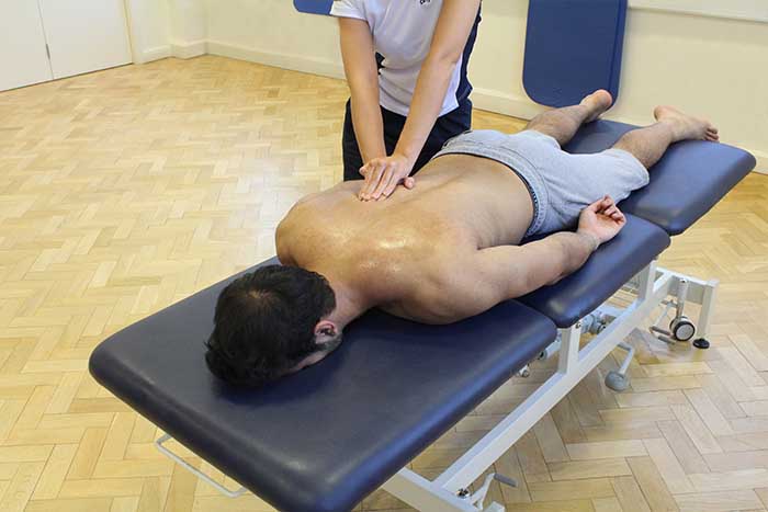 Customer receiving an upper back massage while in a relaxed position