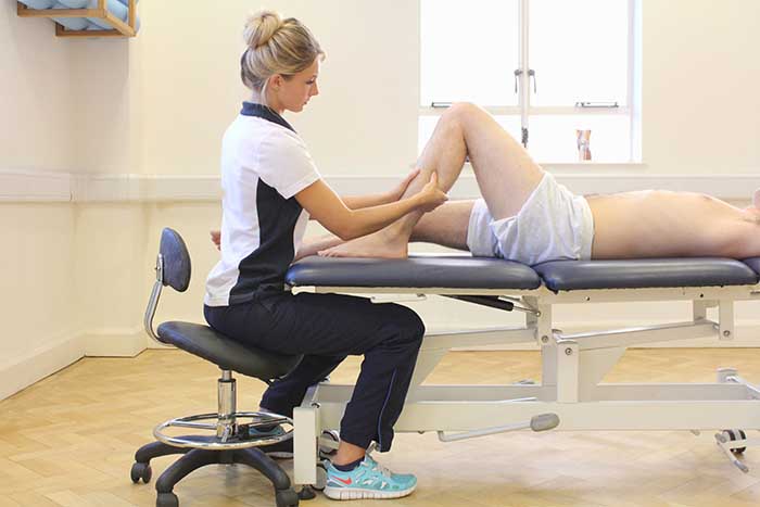 Customer reciving lower leg massage while in a relaxed position Customer reciving lower leg massage while in a relaxed position