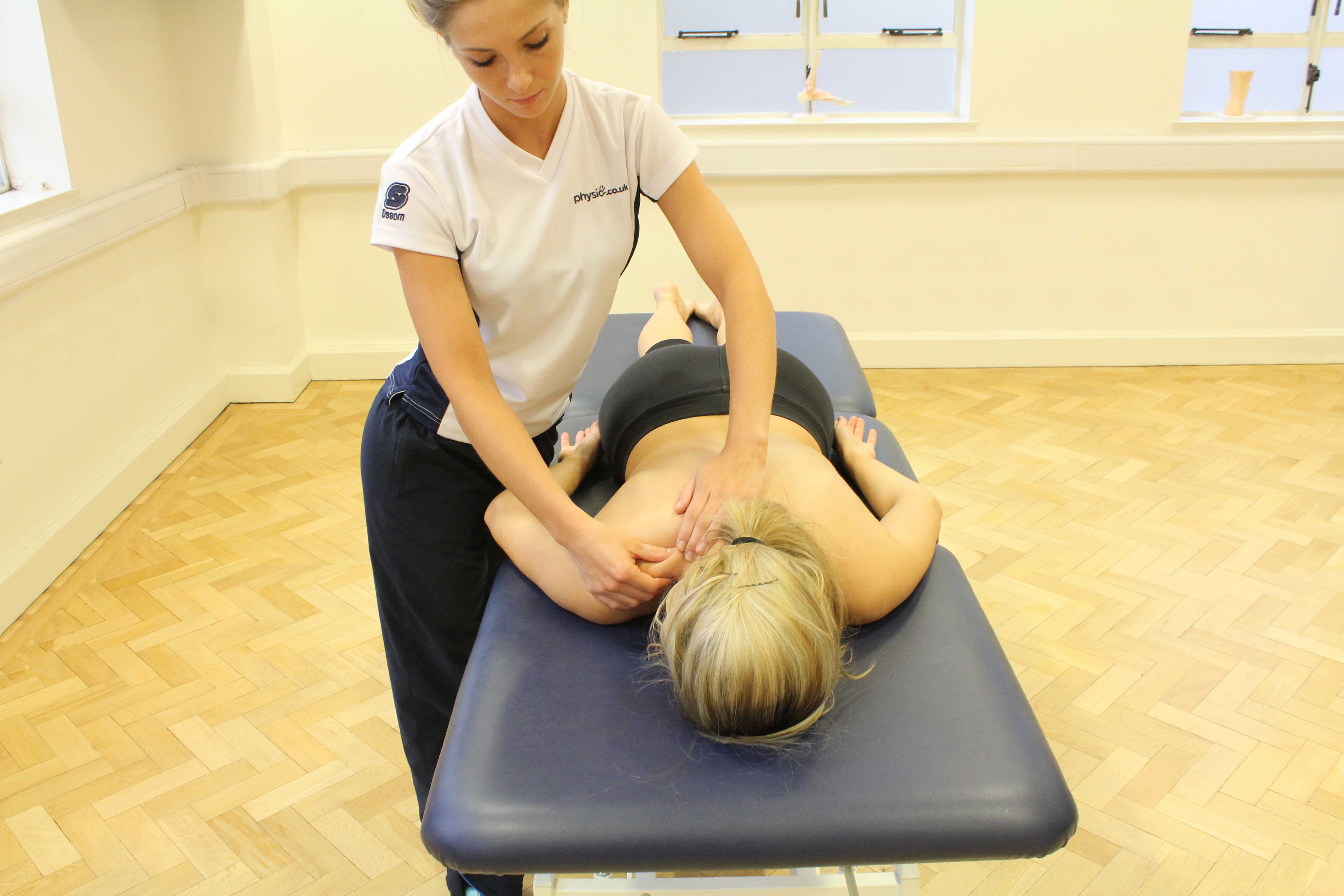 Massage and mobilisations of the trapezious muscles and cervical vertebrea to relieve pain and stiffness