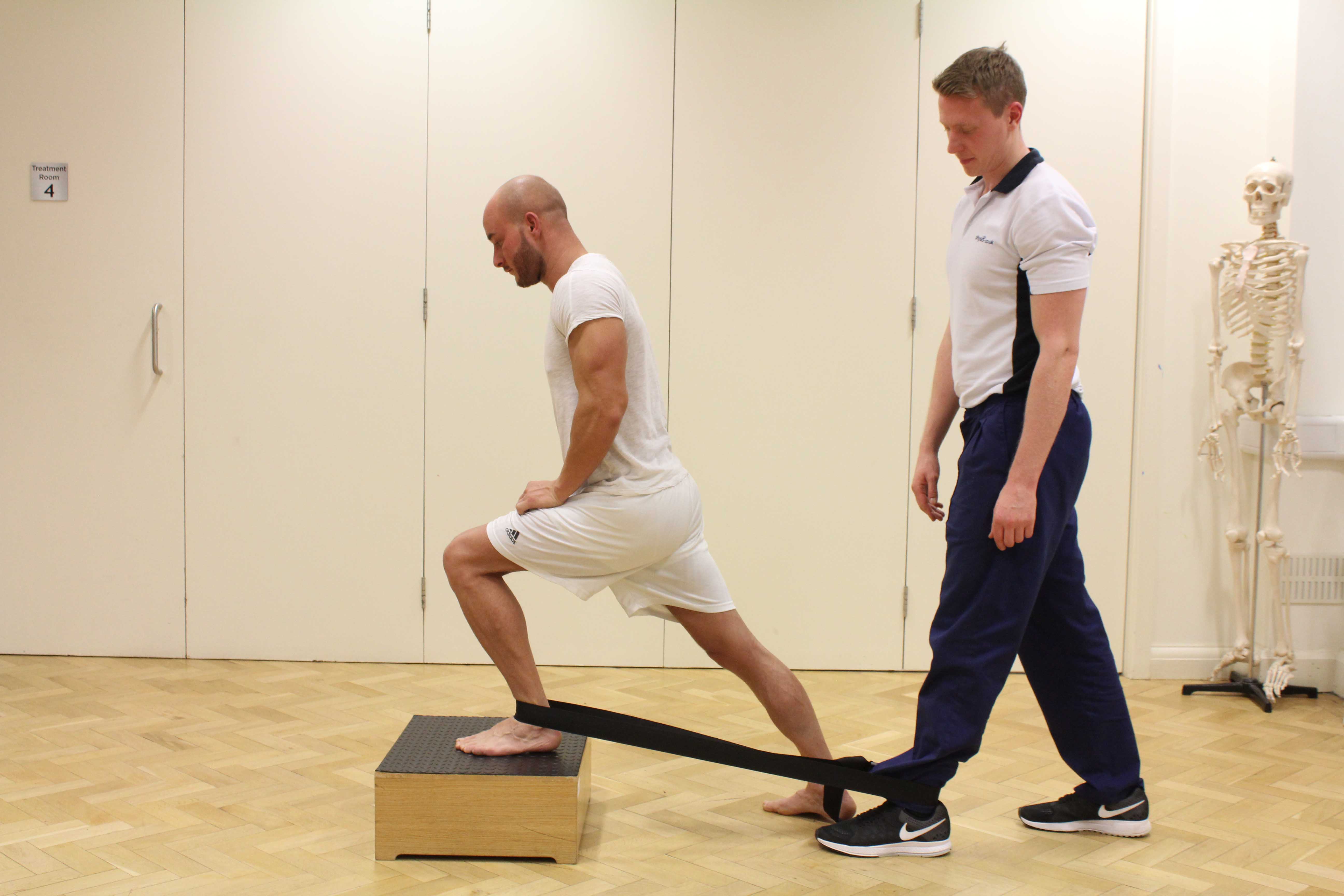 Mobilisation of the ankle joint using a strap and assistance of a MSK physiotherapist