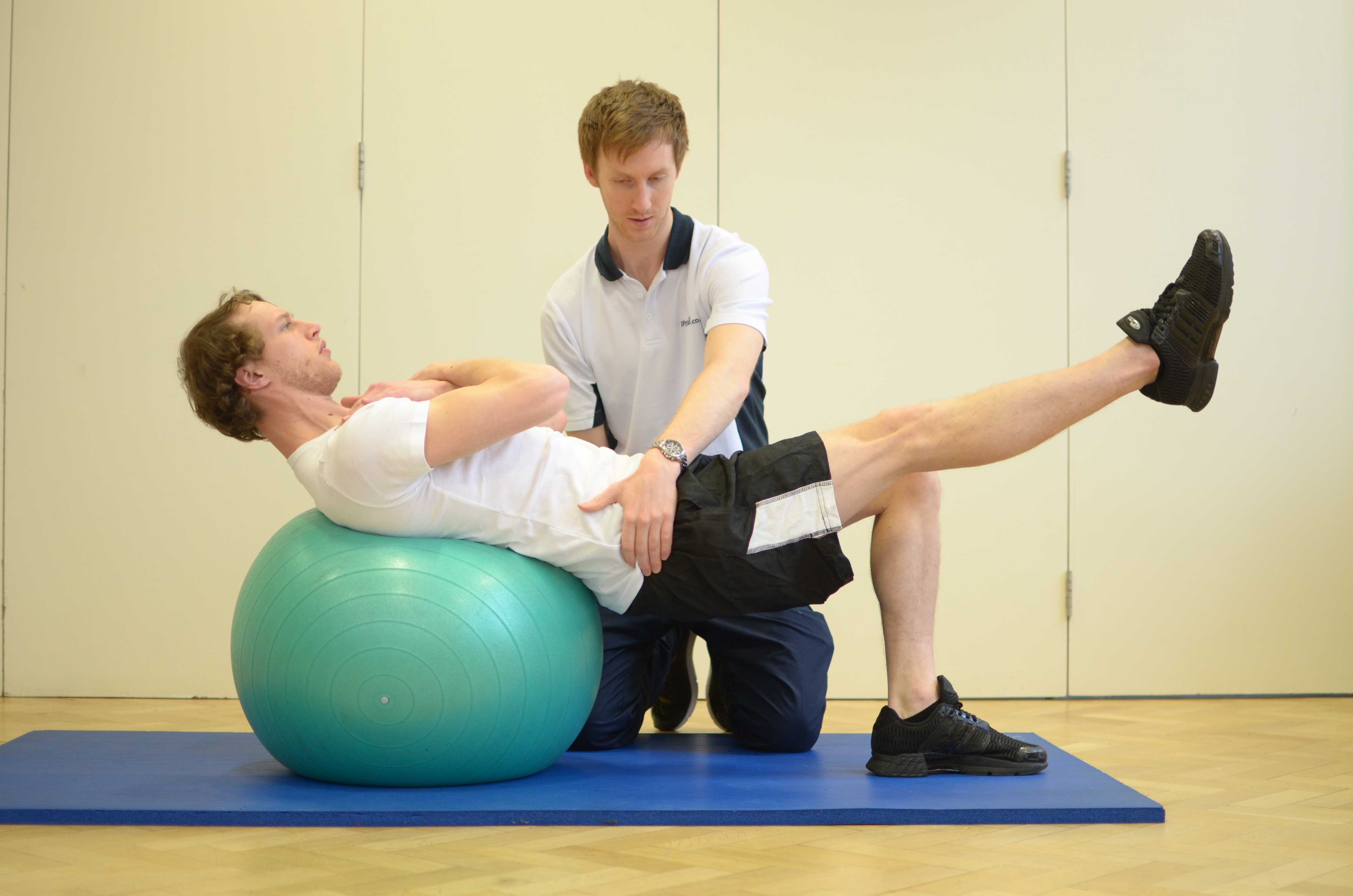 Passive stretch applied by physiotherapist to calf and hamstring muscles