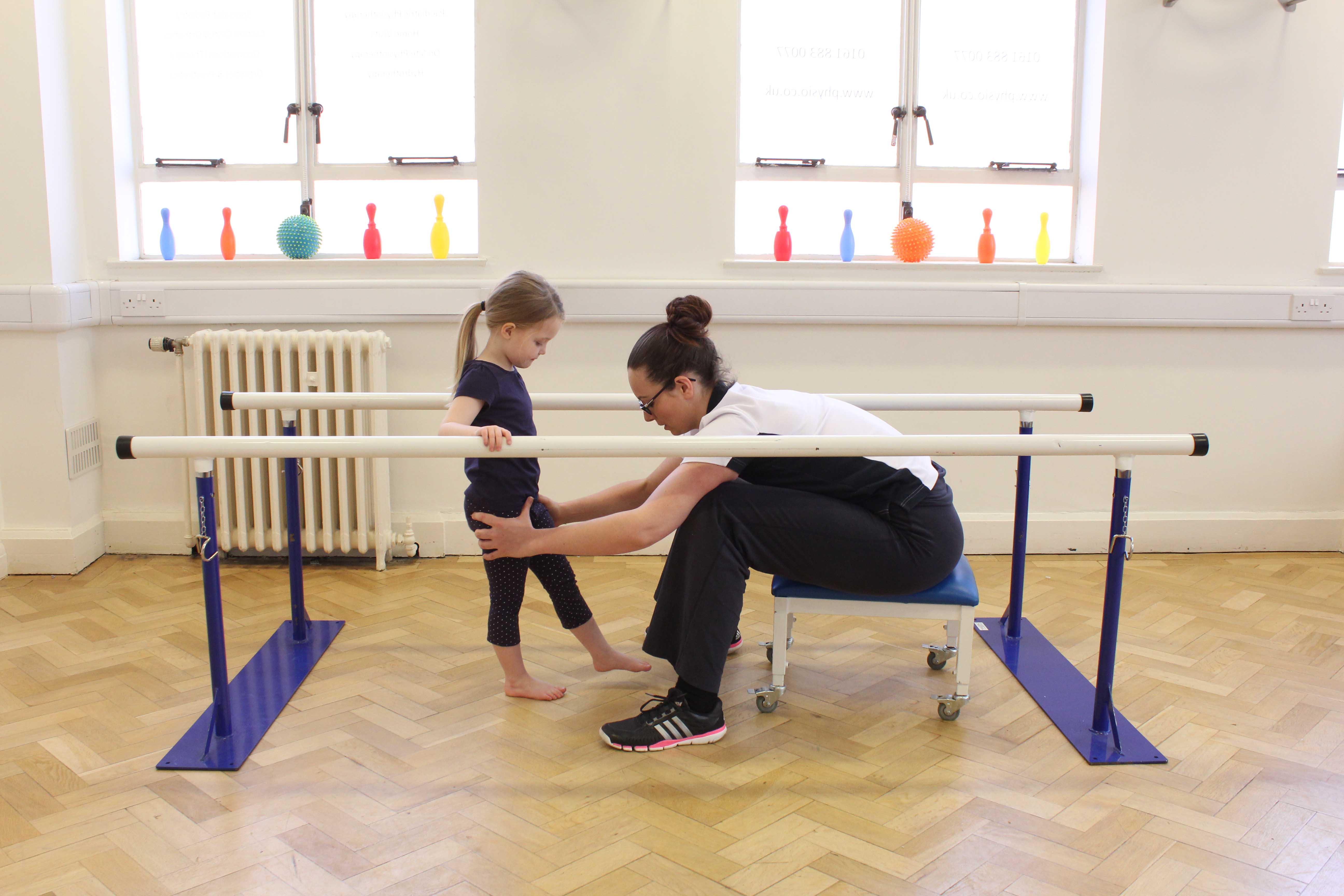 Therapist guiding rehabilitation exercises for patient with musculoskeletal condition.