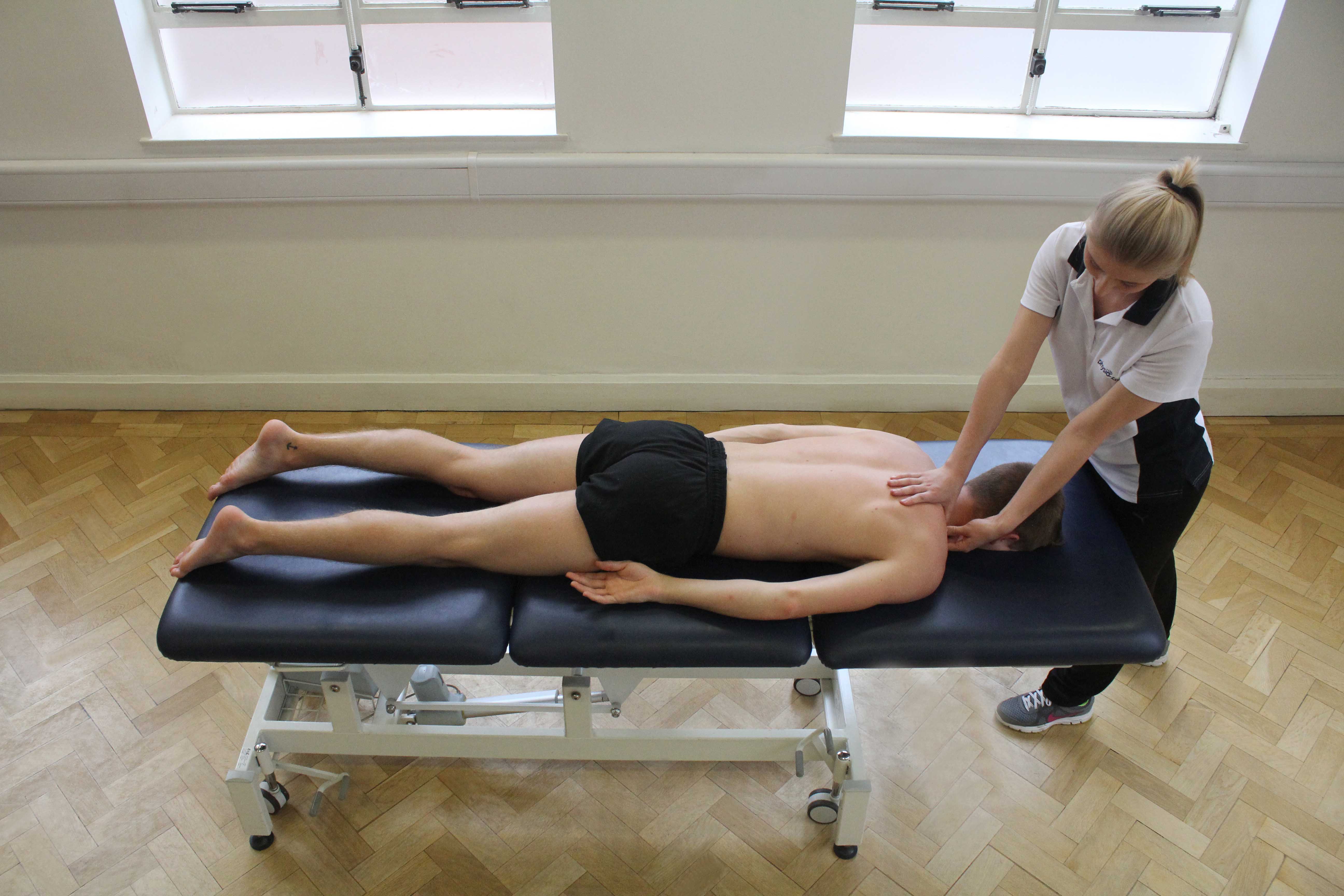 Trigger point massage applied to trapezius muscle Trigger point massage applied to trapezius muscle