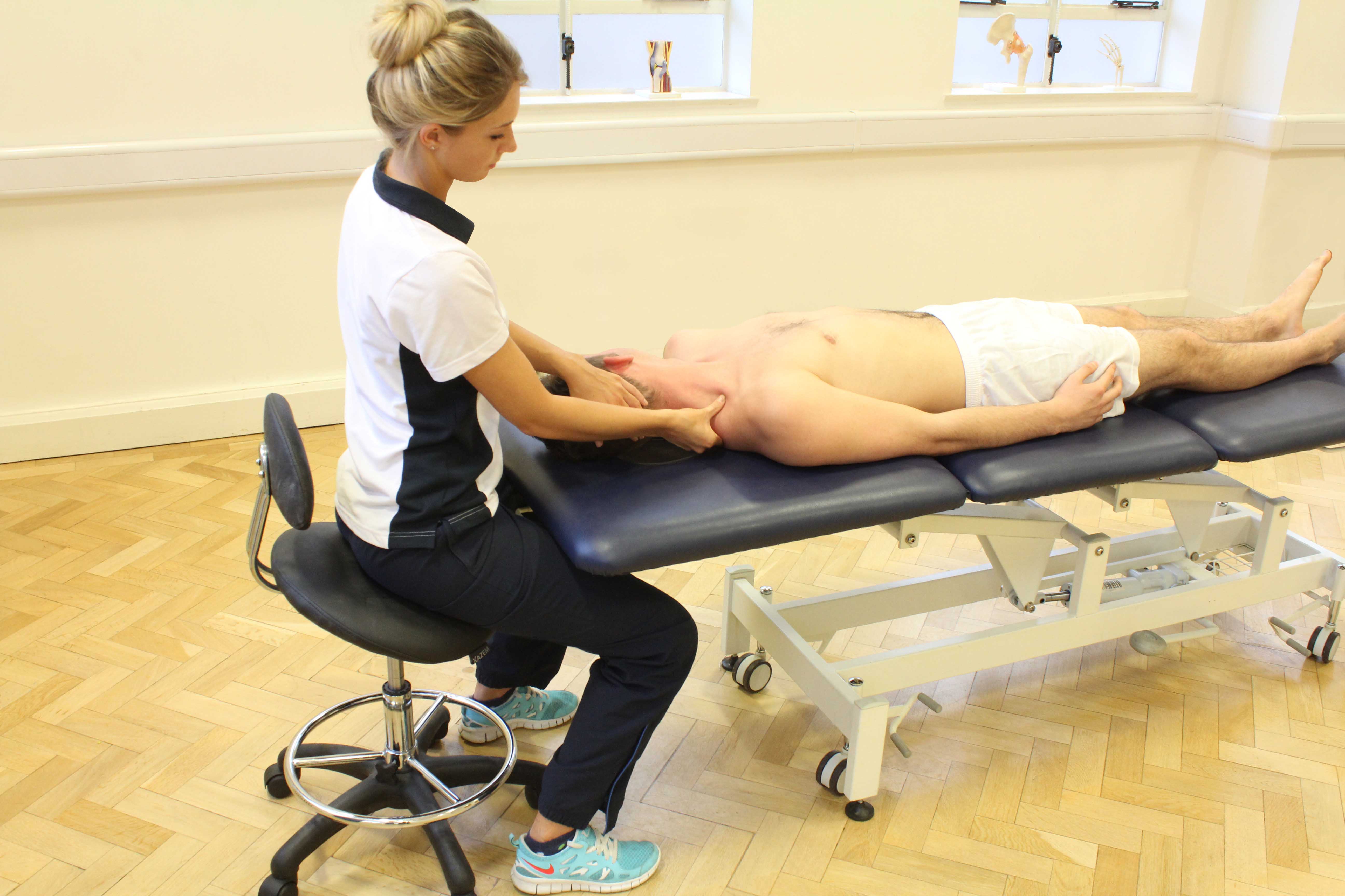 Soft tissue massage of the muscle and connective tissues in the neck by specialist MSK therapist Soft tissue massage of the muscle and connective tissues in the neck by specialist MSK therapist