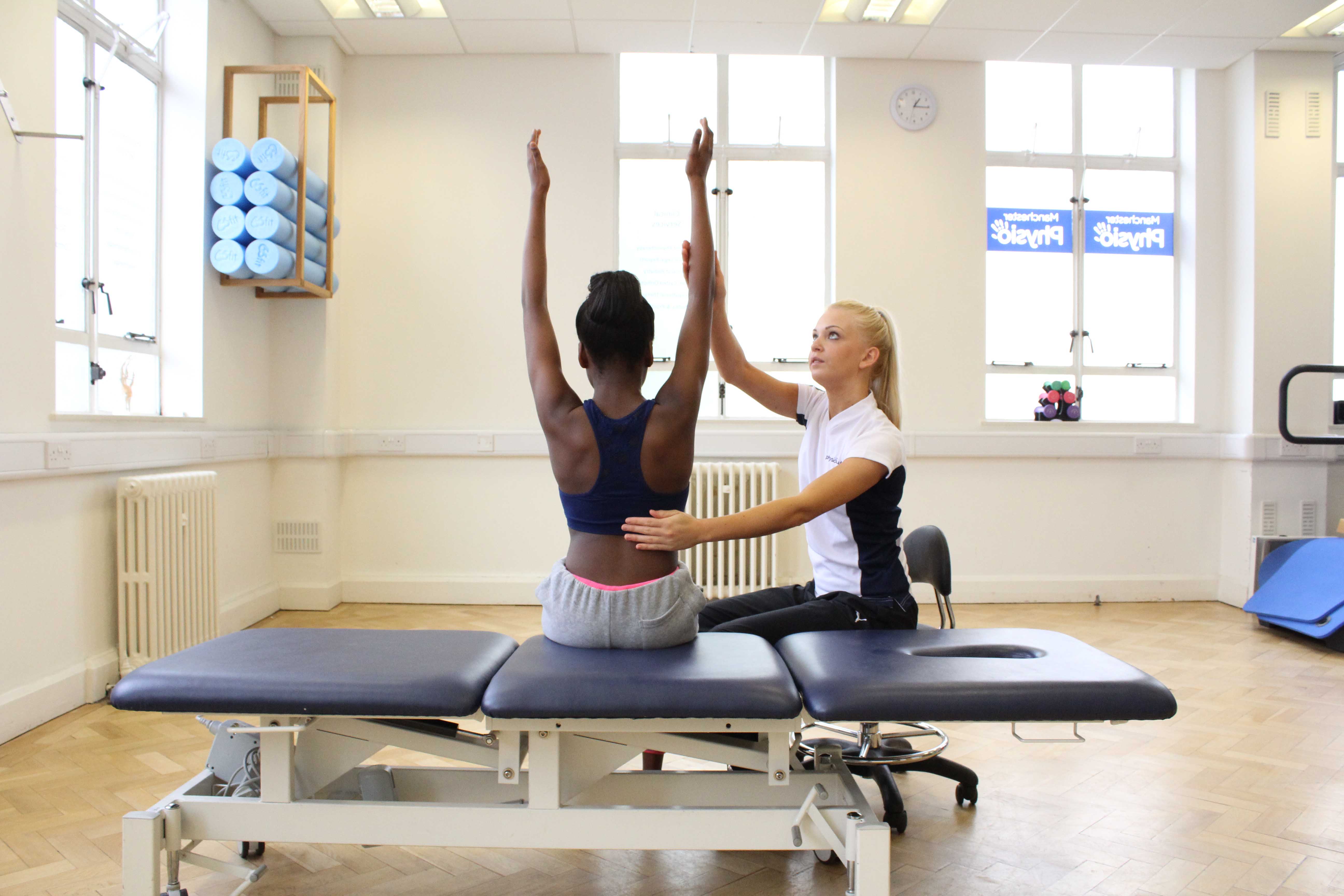 Specialist physiotherapist supervising mobilisation and stretch exercises