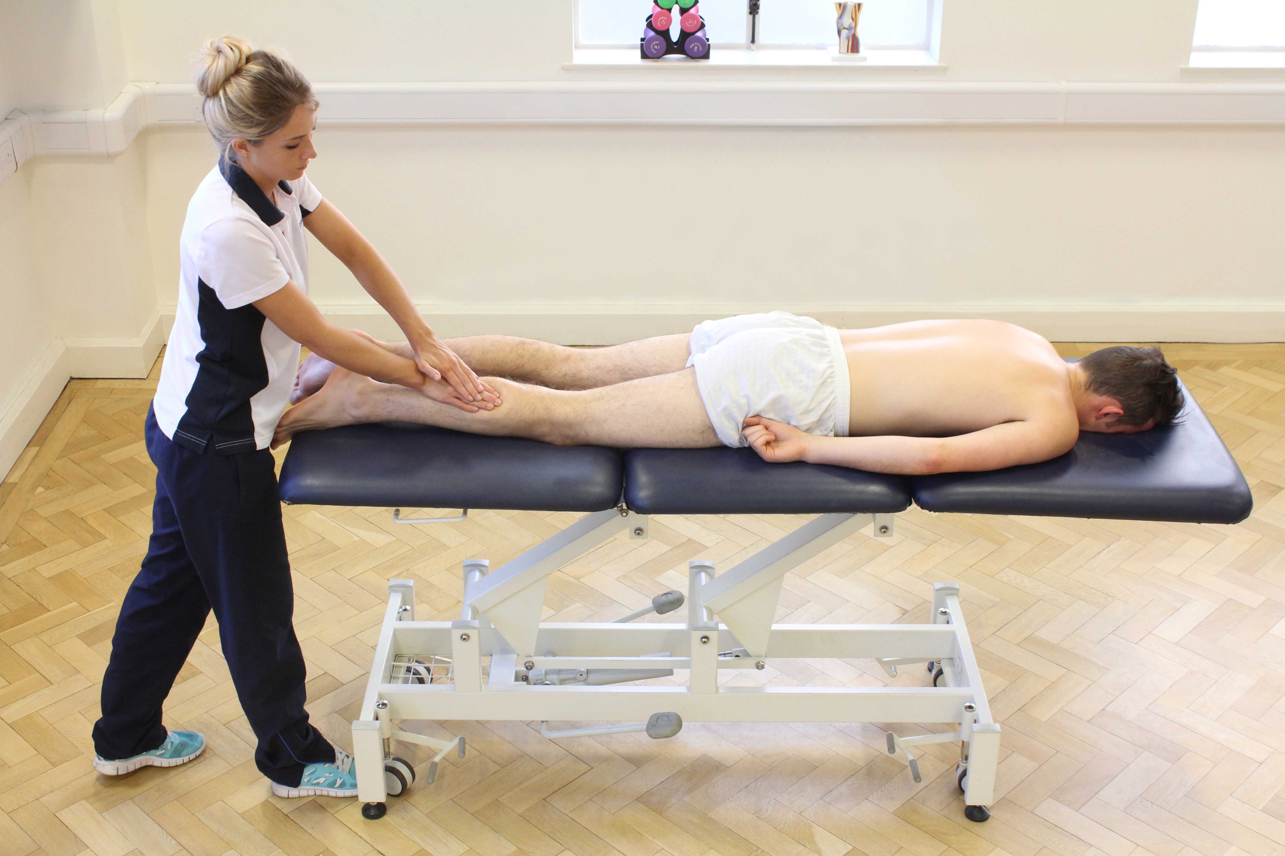 Soft tissue massage of the gastrocnemius muscle by MSK therapist