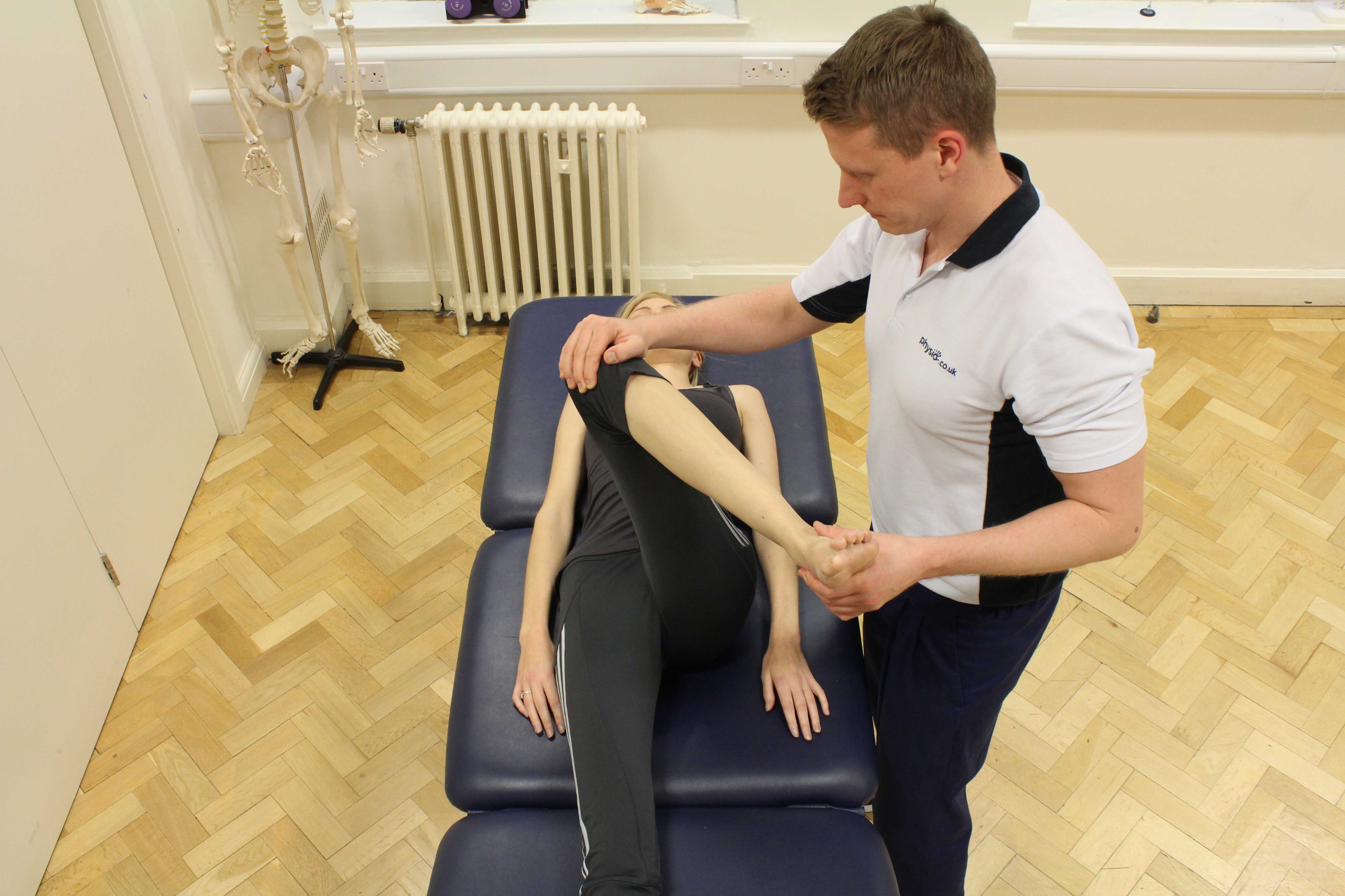 Therapist performing knee assessment