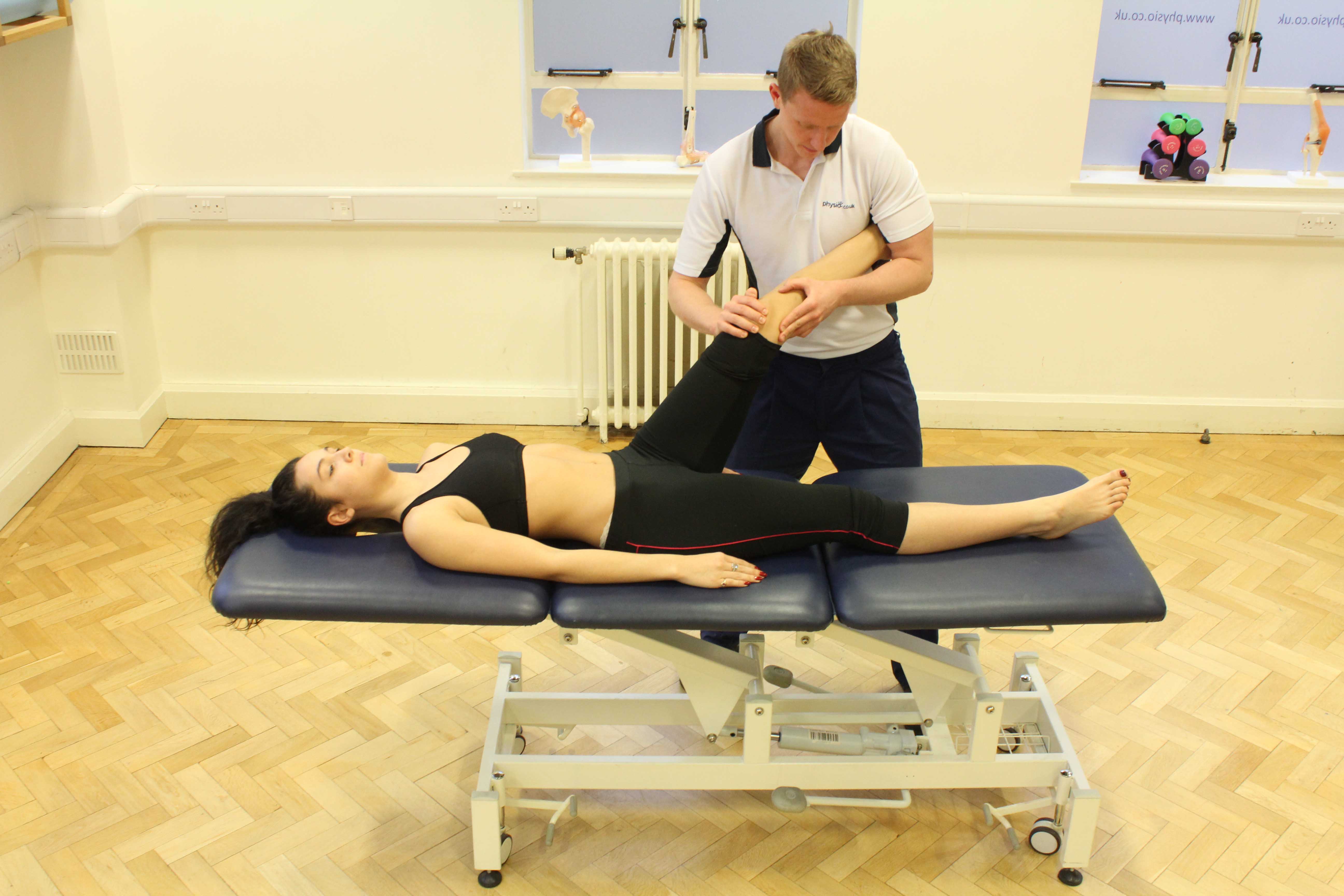 Therapist performing knee assessment