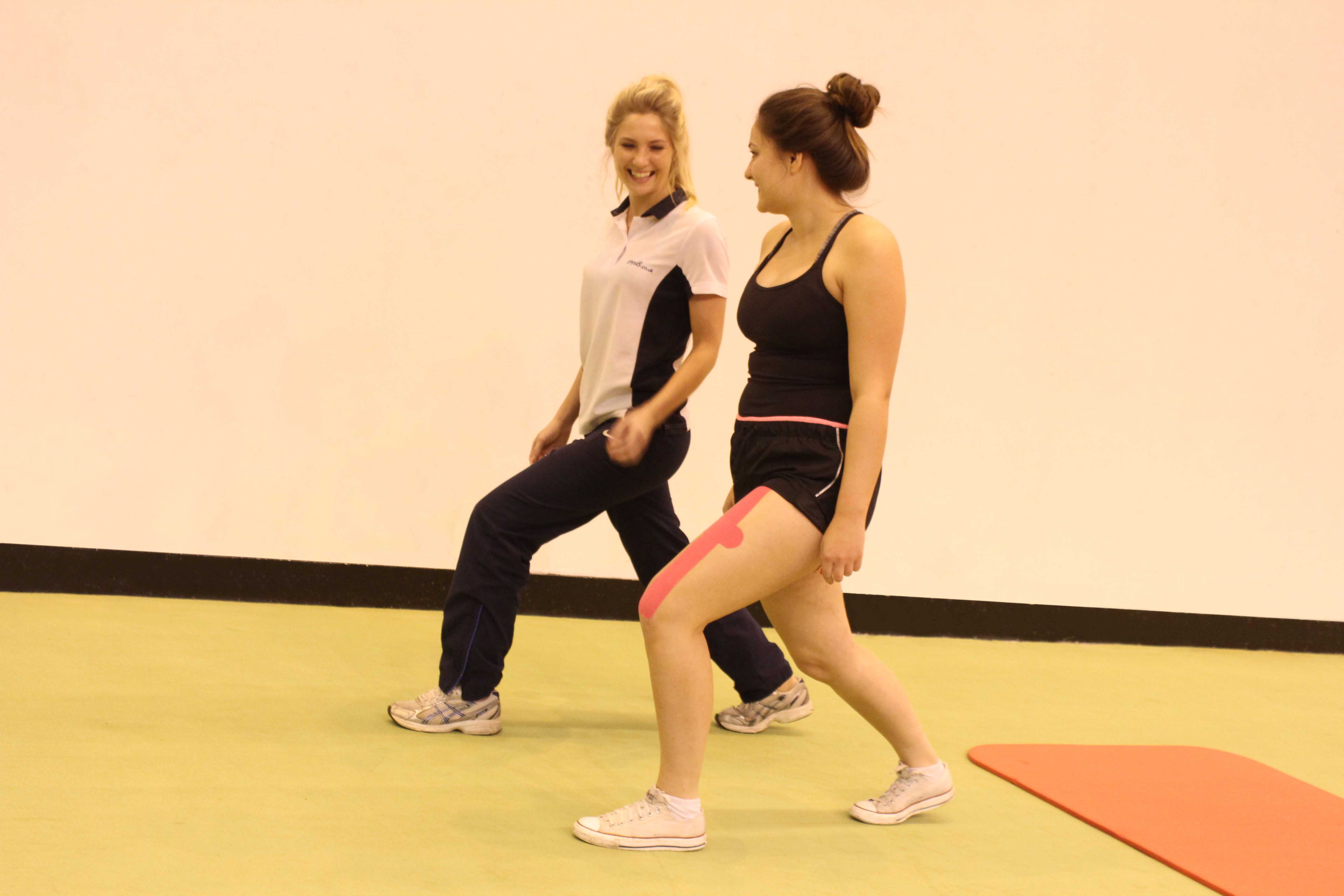 Therapist coaching client through their exercise programme Therapist coaching client through their exercise programme