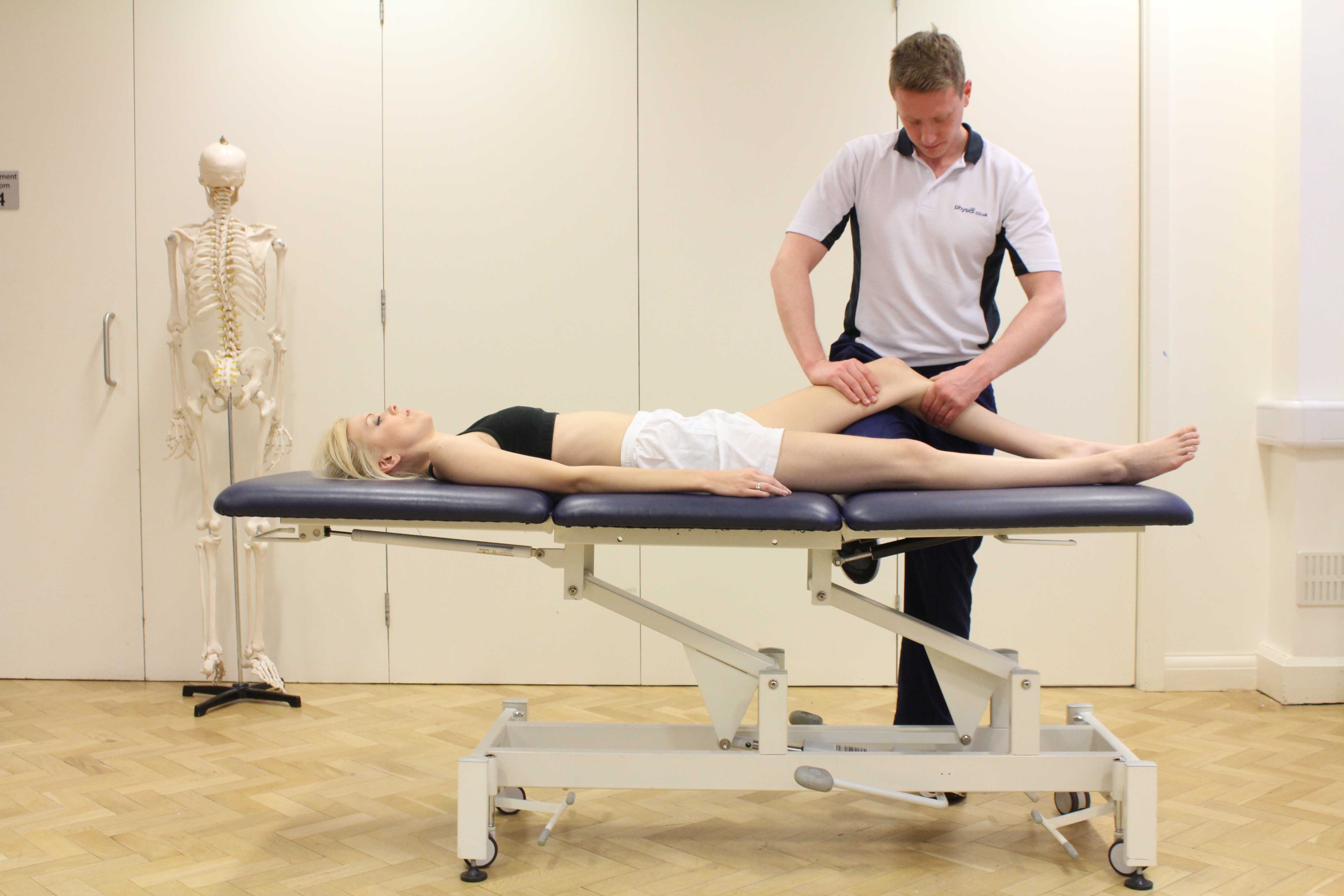 Therapist performing knee assessment Therapist performing knee assessment