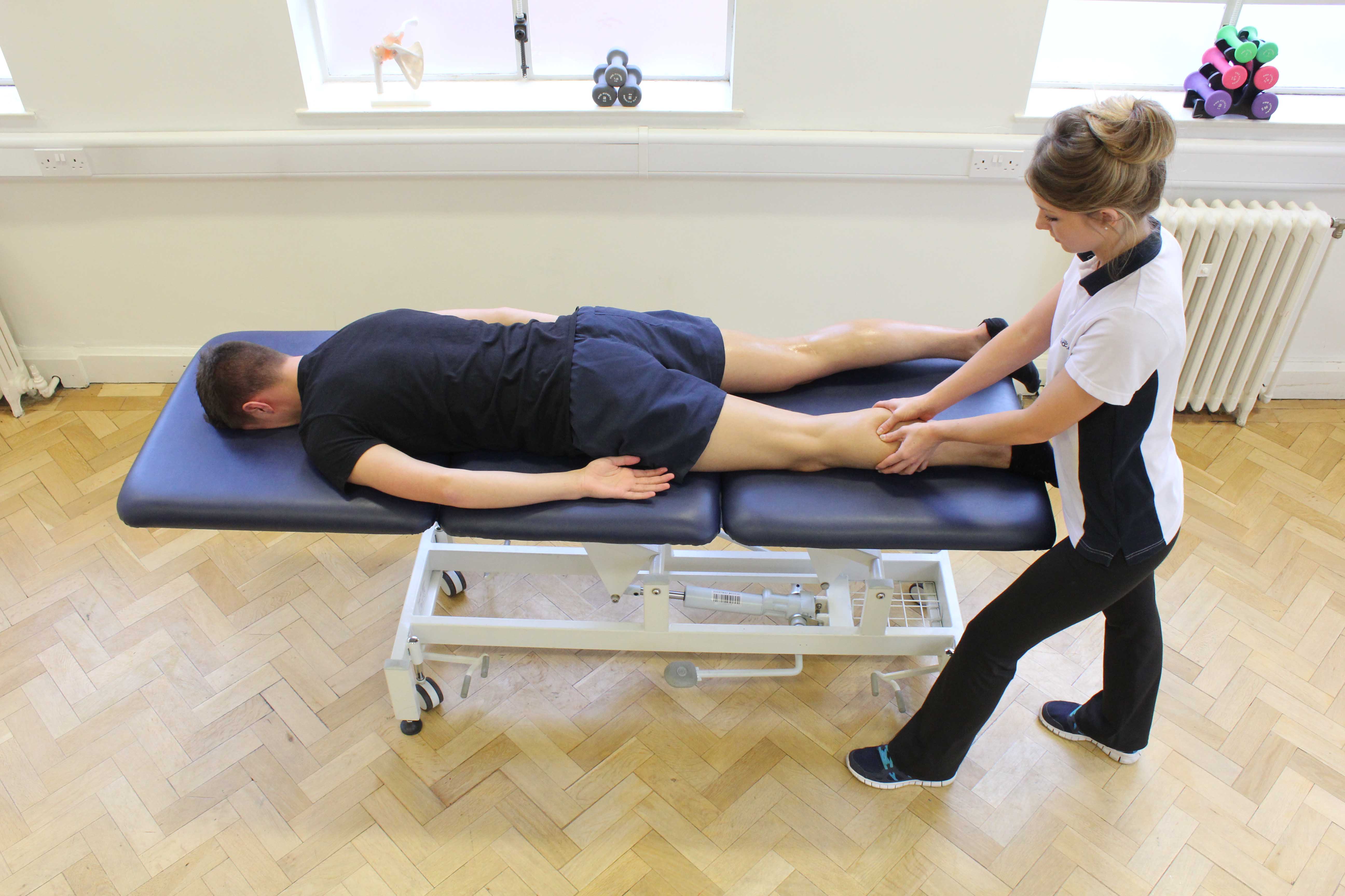 Trigger point massage of the gastroc nemius to relieve painful knotted muscle Trigger point massage of the gastroc nemius to relieve painful knotted muscle