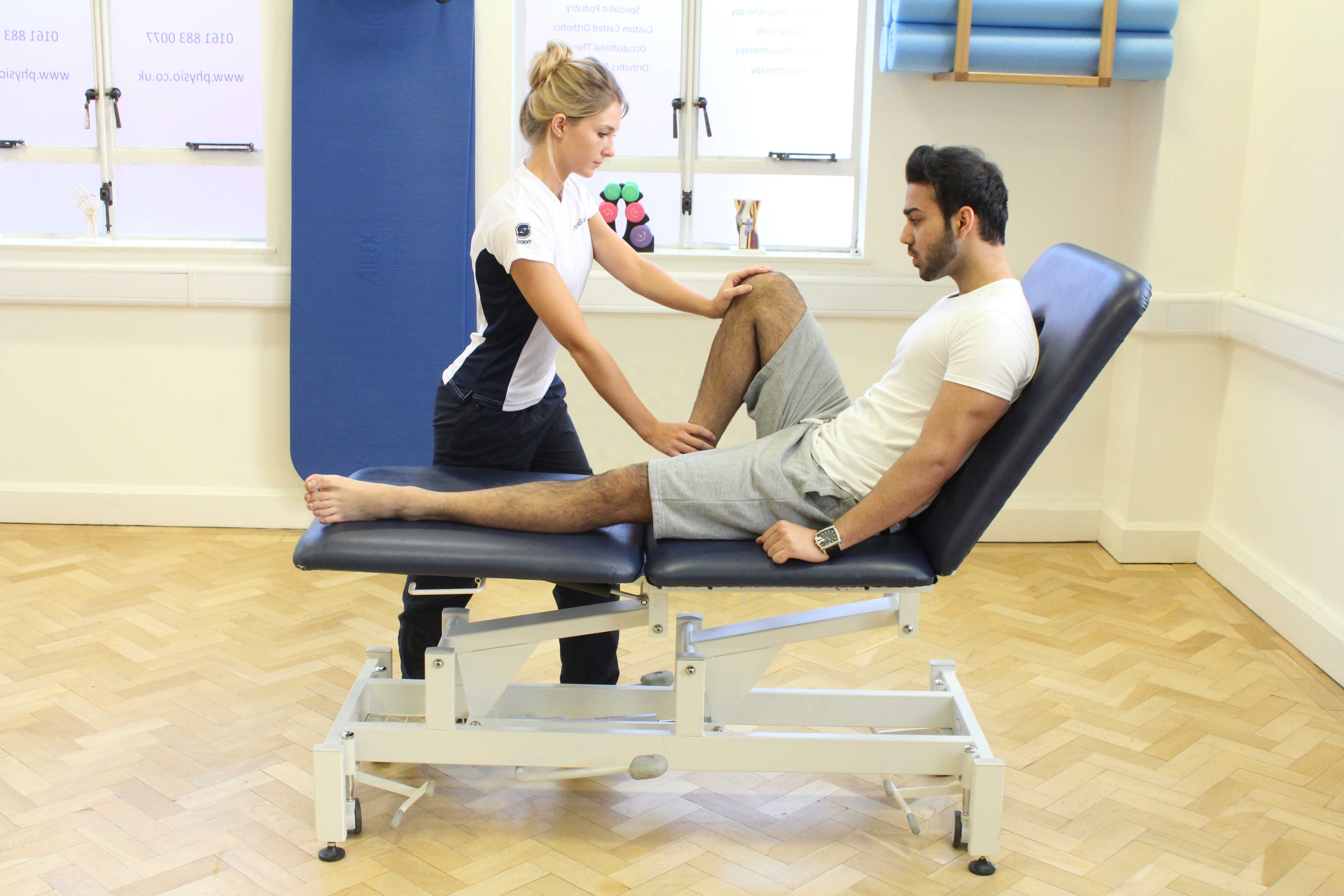 Therapist performing knee assessment Therapist performing knee assessment